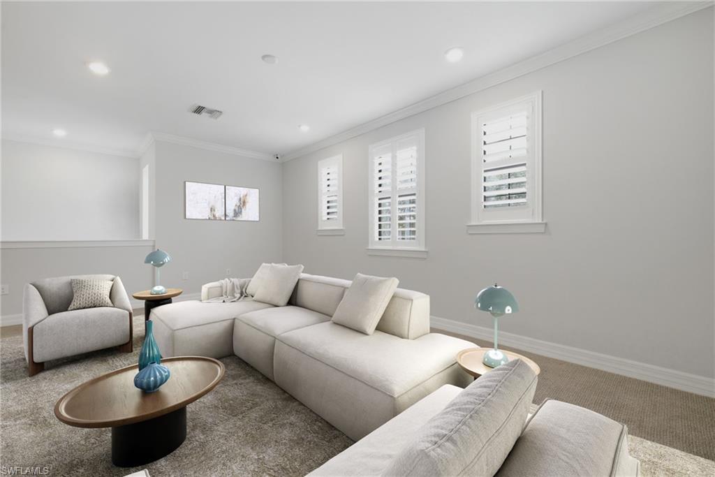 Bright living space featuring recessed lighting, crown molding, white plantation shutters, and a partial wall with a cap