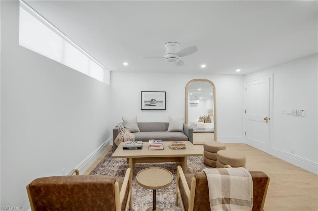 Living area featuring wood finished floors, recessed lighting, and a ceiling fan