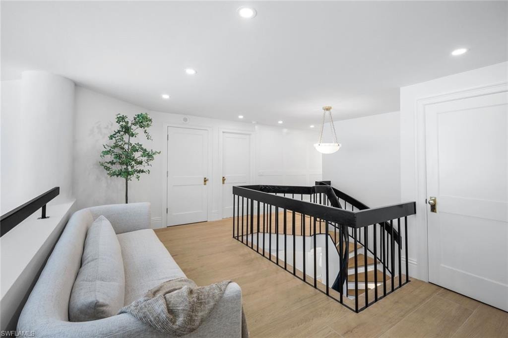 Stairway featuring recessed lighting and wood finished floors