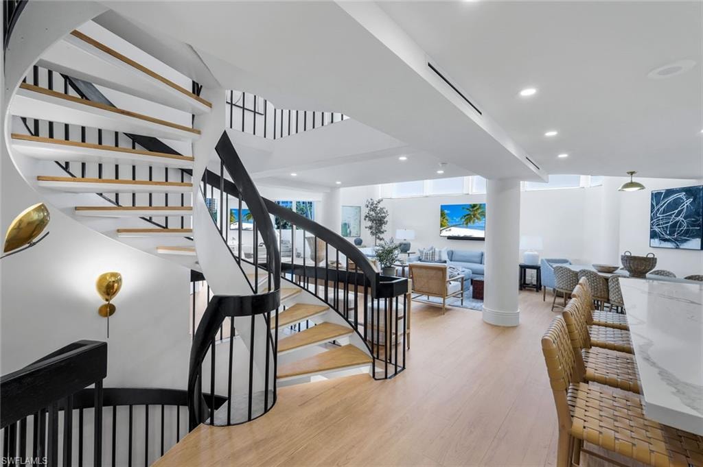 Stairs featuring recessed lighting and wood finished floors