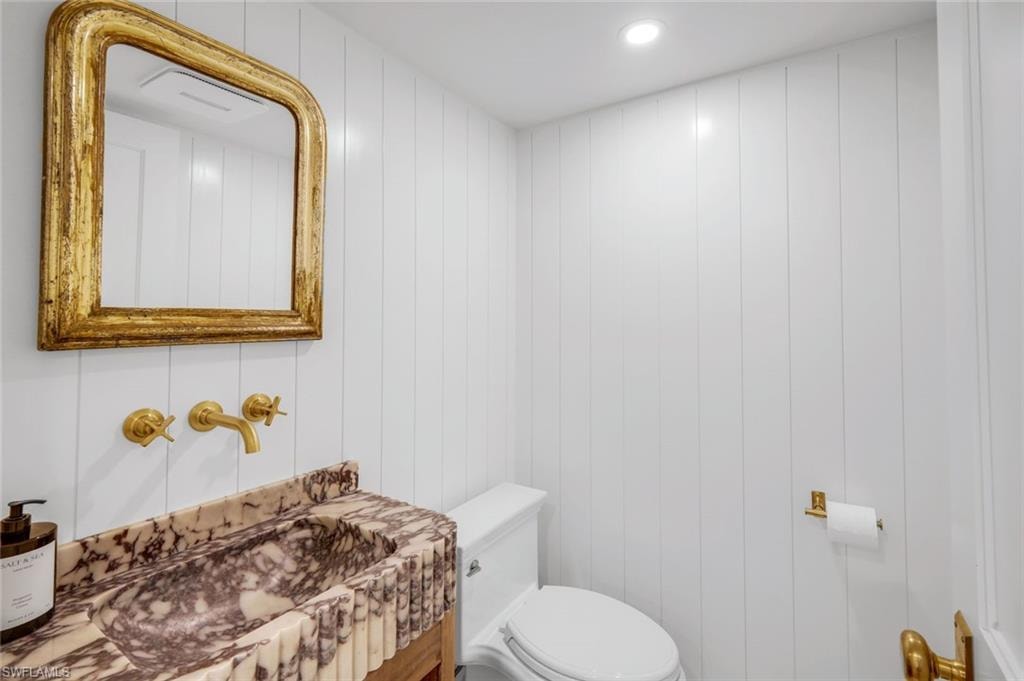 Half bathroom featuring vanity and recessed lighting