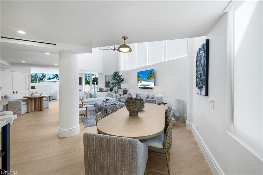 Dining room with light wood-type flooring and recessed lighting