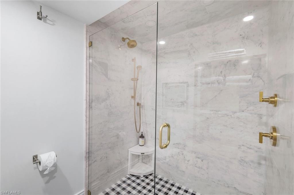 Bathroom with a marble finish shower