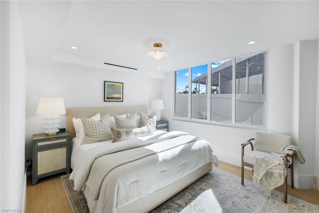 Bedroom with wood finished floors and recessed lighting