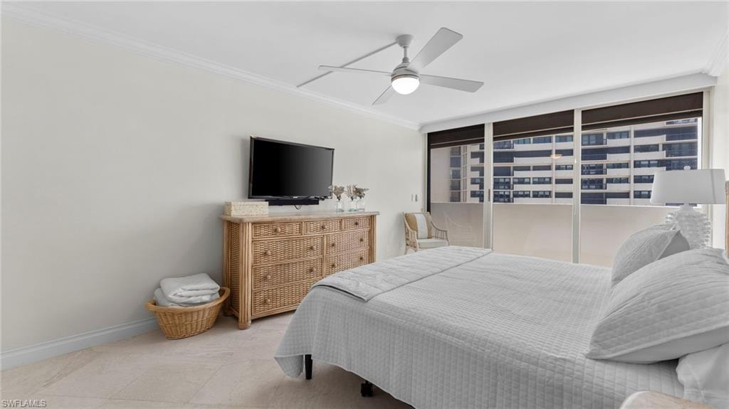 Bedroom with tile patterned flooring, ceiling fan, and crown molding