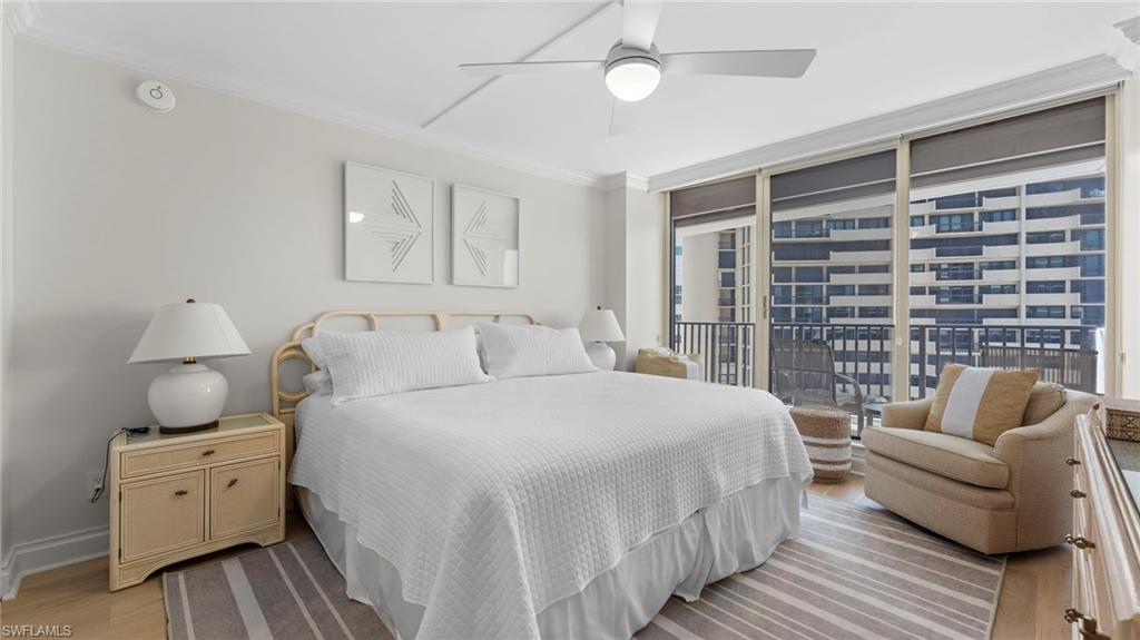Bedroom with a wall of windows, light hardwood / wood-style floors, access to exterior, crown molding, and ceiling fan