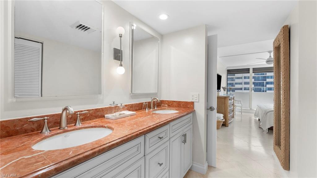 Bathroom with tile patterned flooring, vanity, and ceiling fan