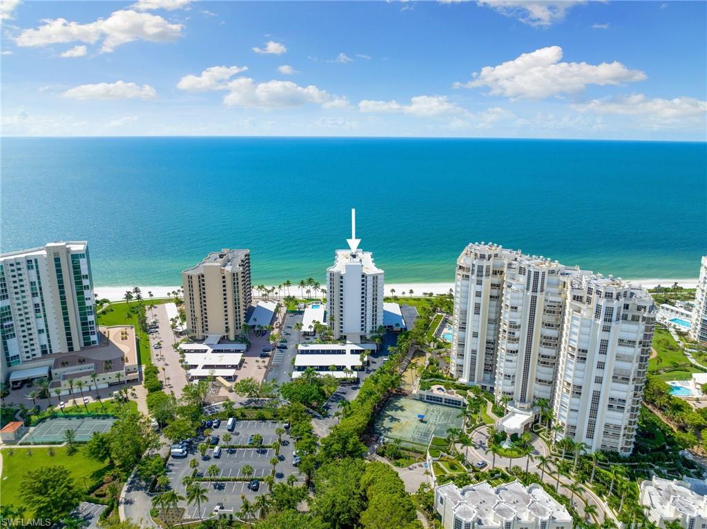 Birds eye view of property with a water view