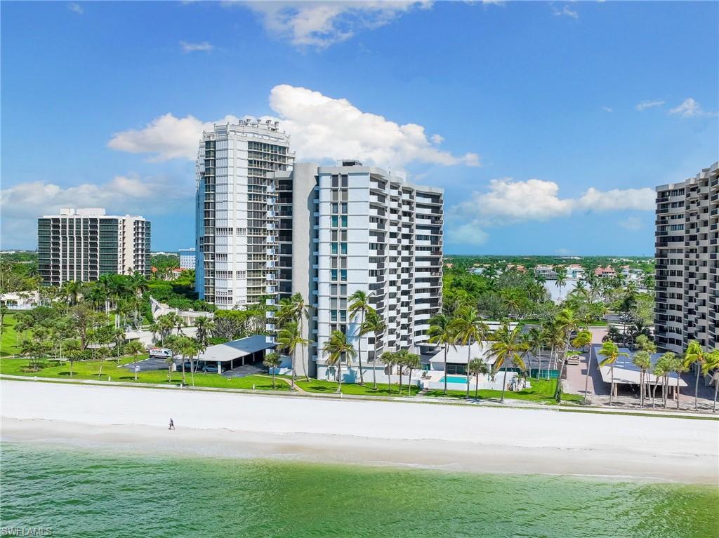 View of building exterior featuring a water view and a beach view