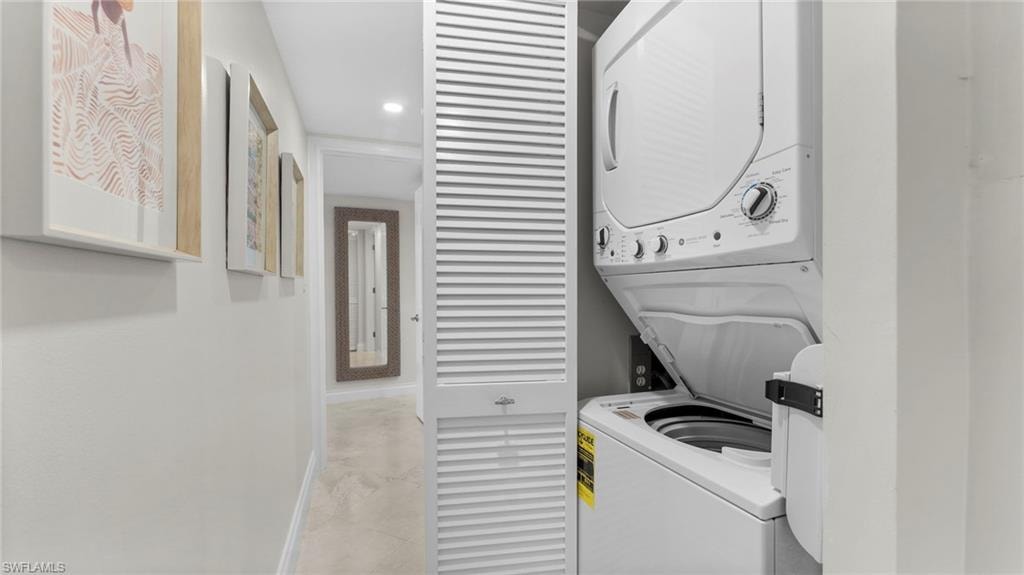 Laundry area featuring stacked washer / drying machine