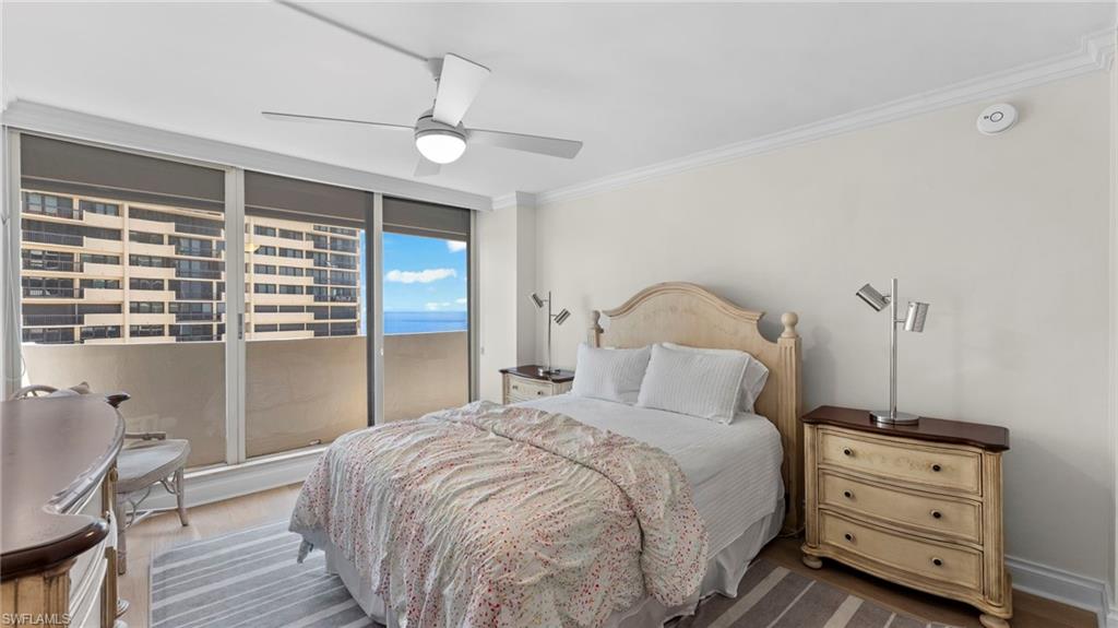 Bedroom featuring access to outside, ornamental molding, wood-type flooring, and ceiling fan
