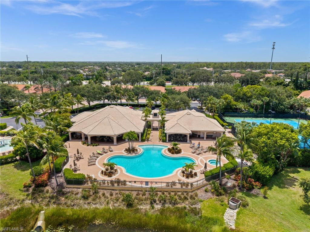 From the air, the resort pool and spa anchor the amenity core, framed by the sun deck, the clubhouse, and the lake beyond.