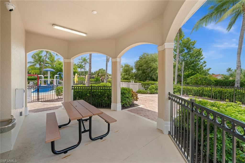 Covered outdoor patio with arched openings, recessed lighting, and a built-in water fountain