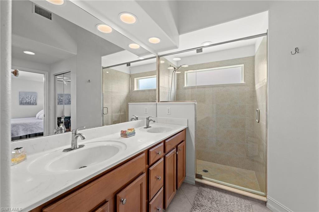 Dual vanity with undermount sinks and chrome fixtures, set against a full-width mirror