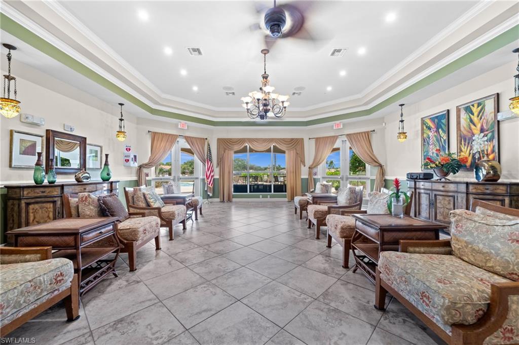 Spacious common area featuring large format tile flooring, crown molding, and recessed lighting