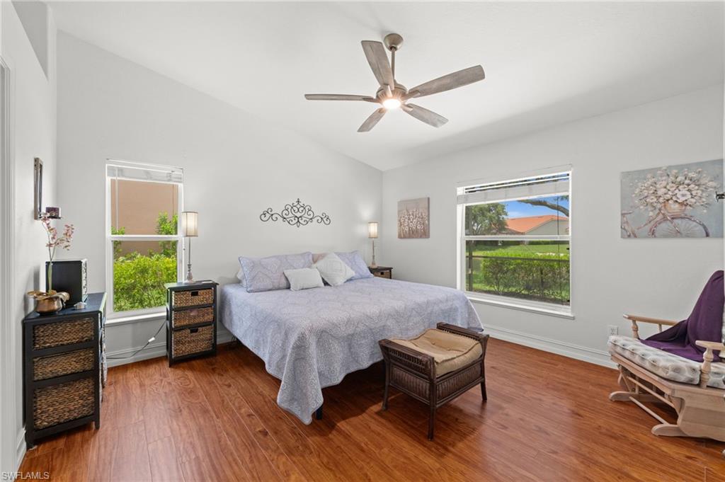 Interior space featuring wood-finish flooring, vaulted ceilings, and white walls