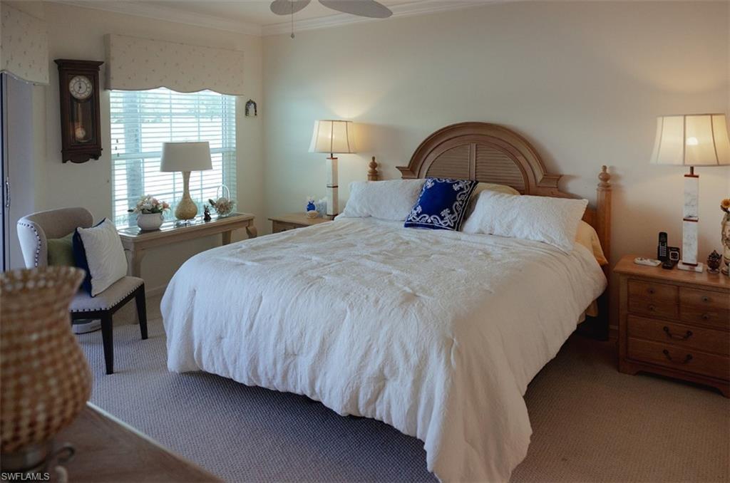 Bedroom with carpet flooring, crown molding, and ceiling fan