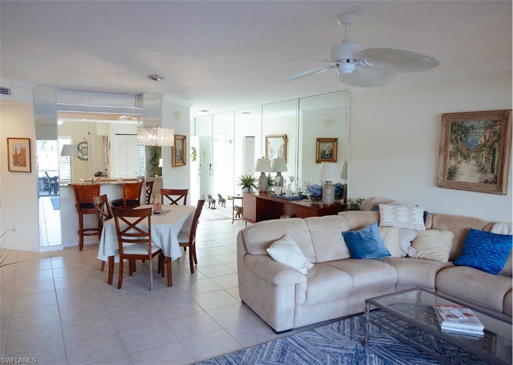 Living room featuring ceiling fan and light tile patterned floors