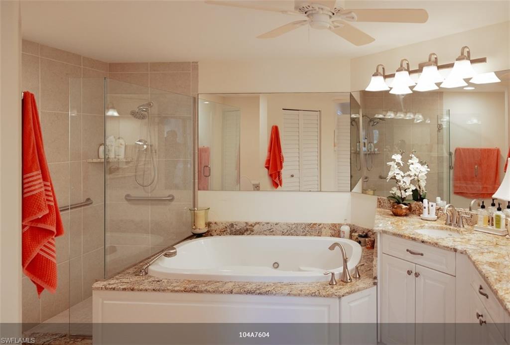 Bathroom with vanity, ceiling fan, and independent shower and bath