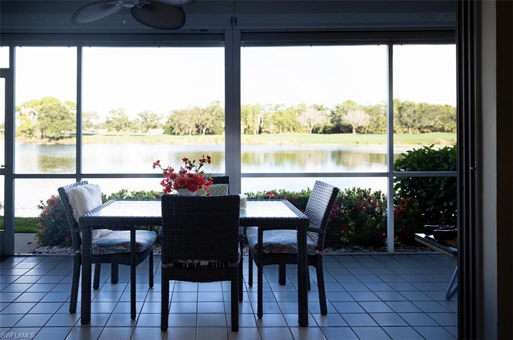 Sunroom with ceiling fan, a water view, and plenty of natural light