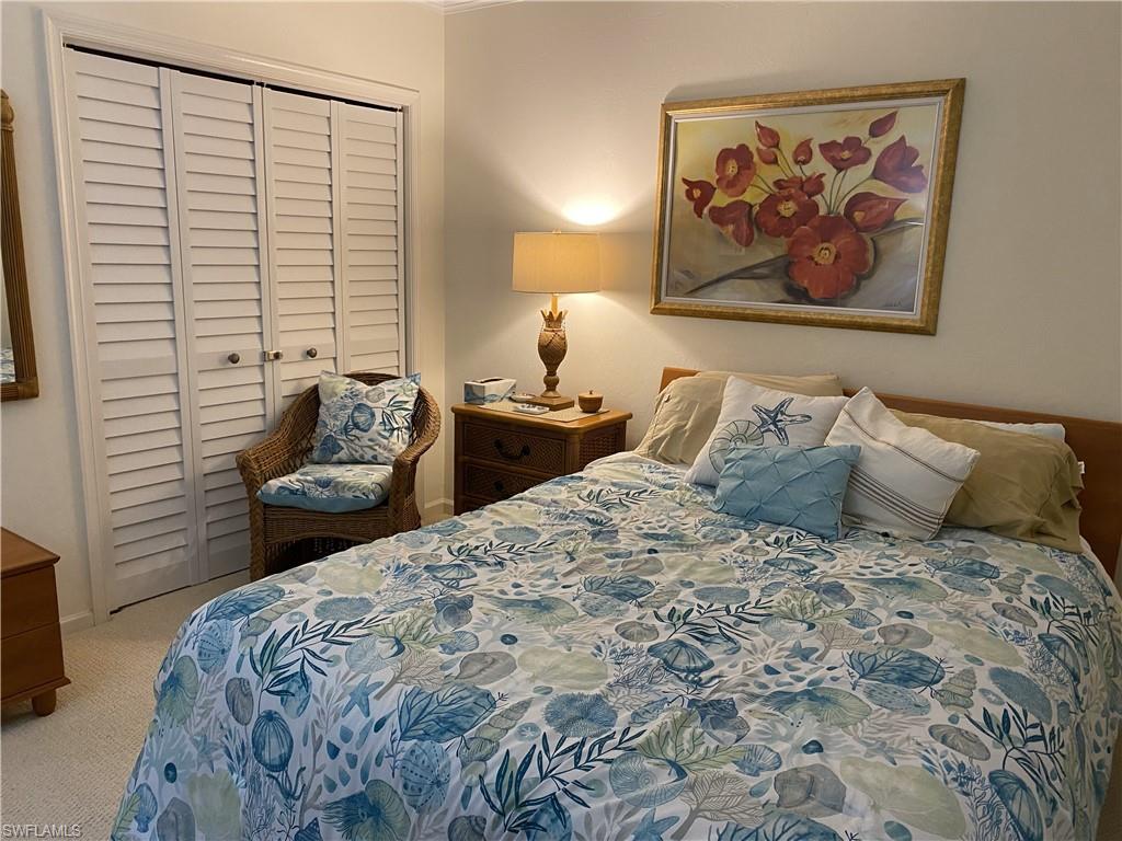 Bedroom featuring light carpet and a closet