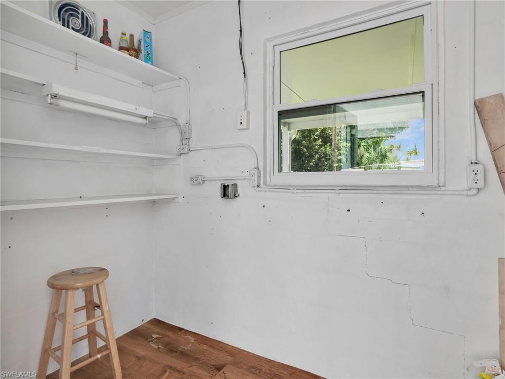 Interior space featuring white walls, multi-level shelving, and a single window