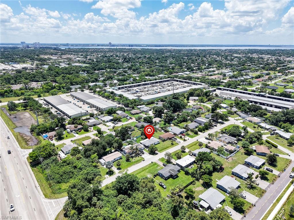 Aerial perspective highlighting a residential neighborhood with surrounding commercial structures