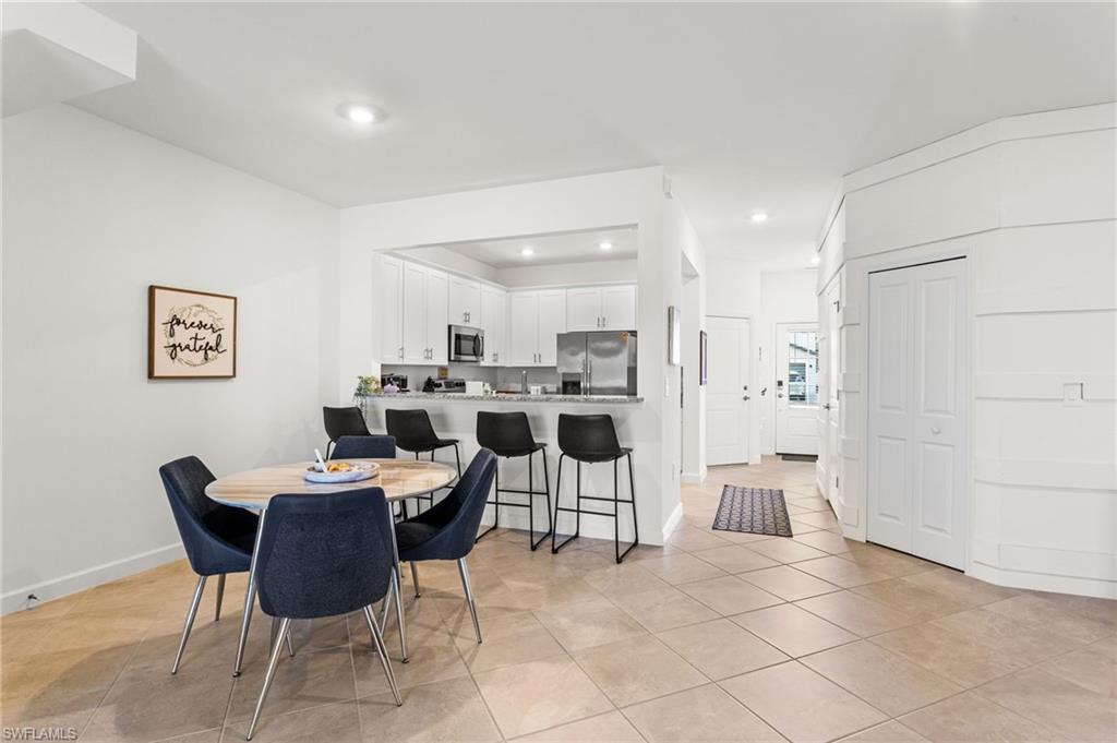 The adjoining living and dining areas are open, airy, and perfect for both relaxing and entertaining