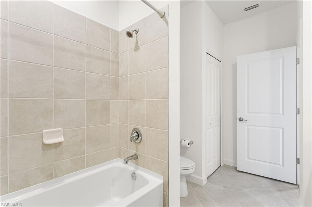Upstairs second full bathroom featuring a tub/shower combination, ideal for family or guests