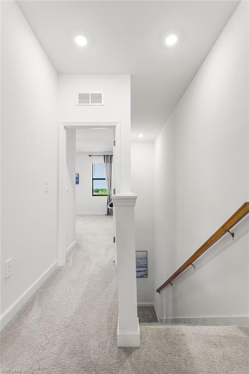 Bright upstairs hallway with recessed lighting, connecting the bedrooms and living spaces with ease