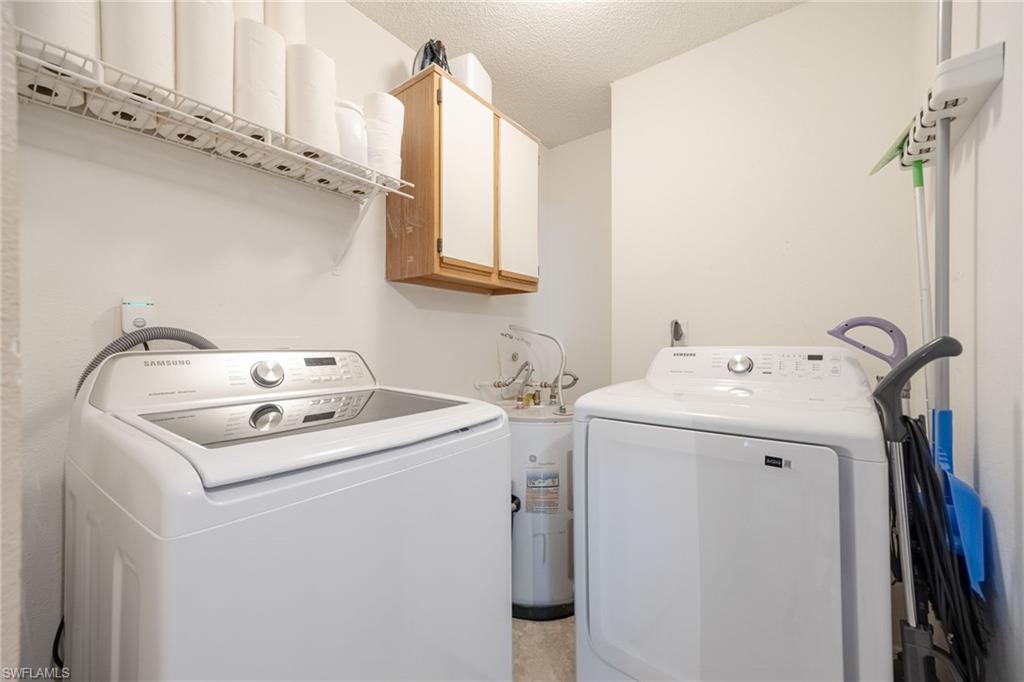 Dedicated utility space featuring a white top-load washer and front-load dryer