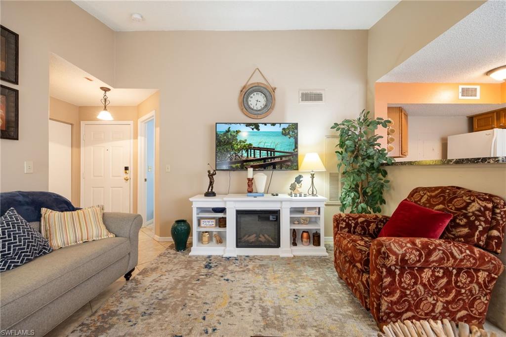 Living space with vaulted ceiling and tile flooring