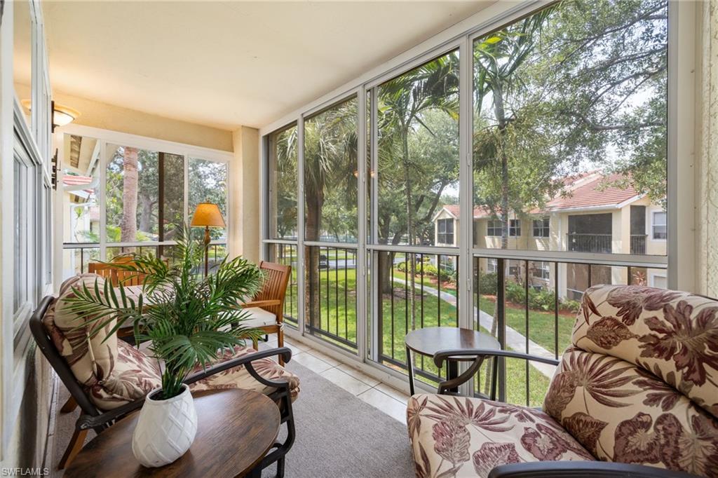 Screened balcony featuring tile flooring and a textured ceiling
