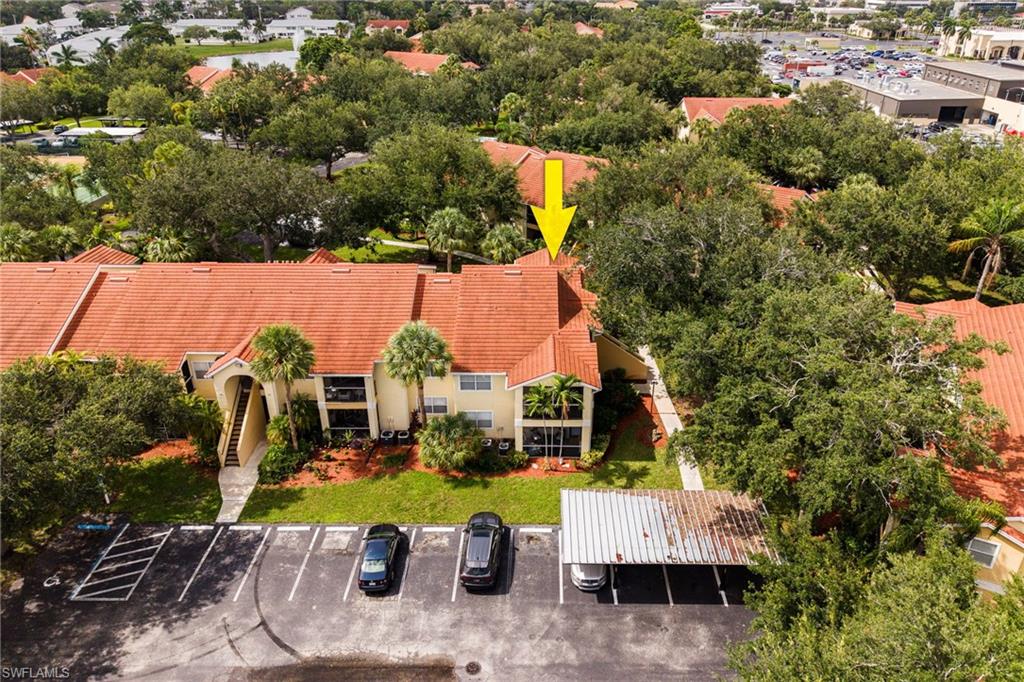 Multi-story residential building featuring a tile roof and stucco exterior