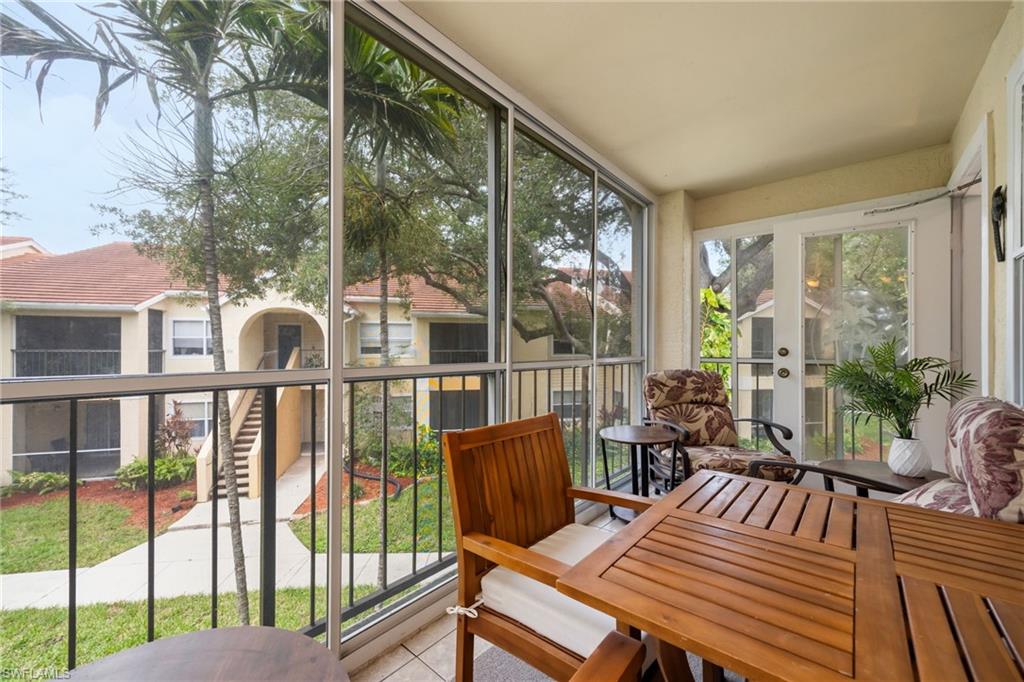 Screened balcony featuring tiled flooring and a white ceiling