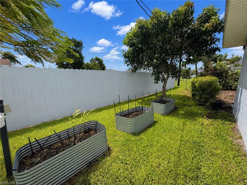 Left Side of home - Showing Fruit trees/Herb Flower Bed