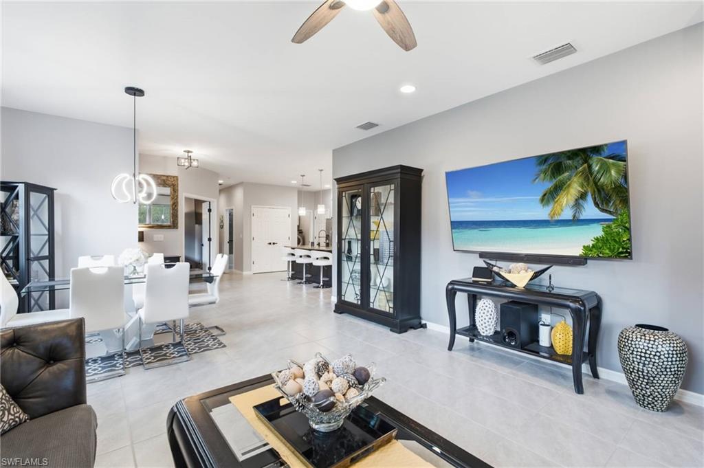 Open-concept living area featuring light gray wall paint and tile flooring throughout