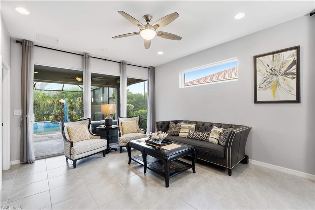 Spacious interior room featuring tile flooring and a ceiling fan