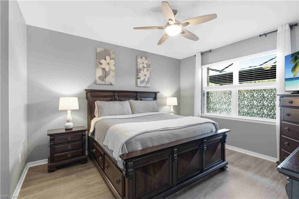 Bedroom featuring neutral gray walls and wood-finish flooring
