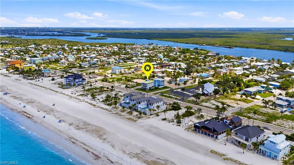Aerial perspective showcasing a coastal community with direct beach access - Virtually Edited Image