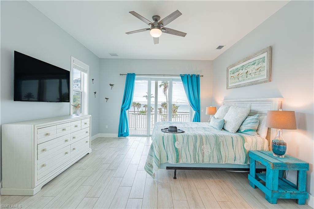 Bedroom featuring light wood-finish flooring and a ceiling fan - Virtually Edited Image