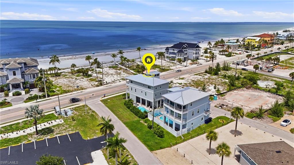 Multi-story coastal residence featuring a flat roof and multiple balconies - Virtually Edited Image