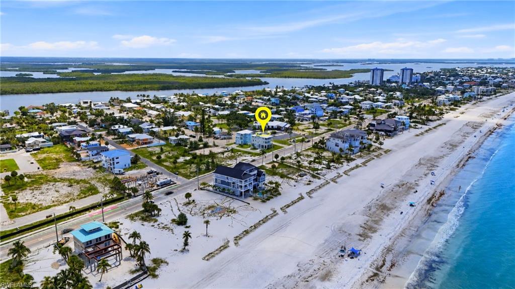 Coastal property offering direct beach access, featuring a white sand shoreline and turquoise waters - Virtually Edited Image
