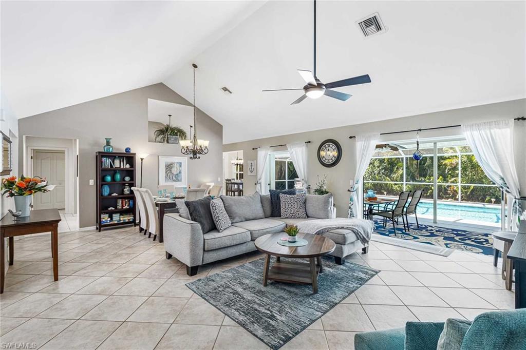 The spacious living room has comfortable seating & vaulted ceilings