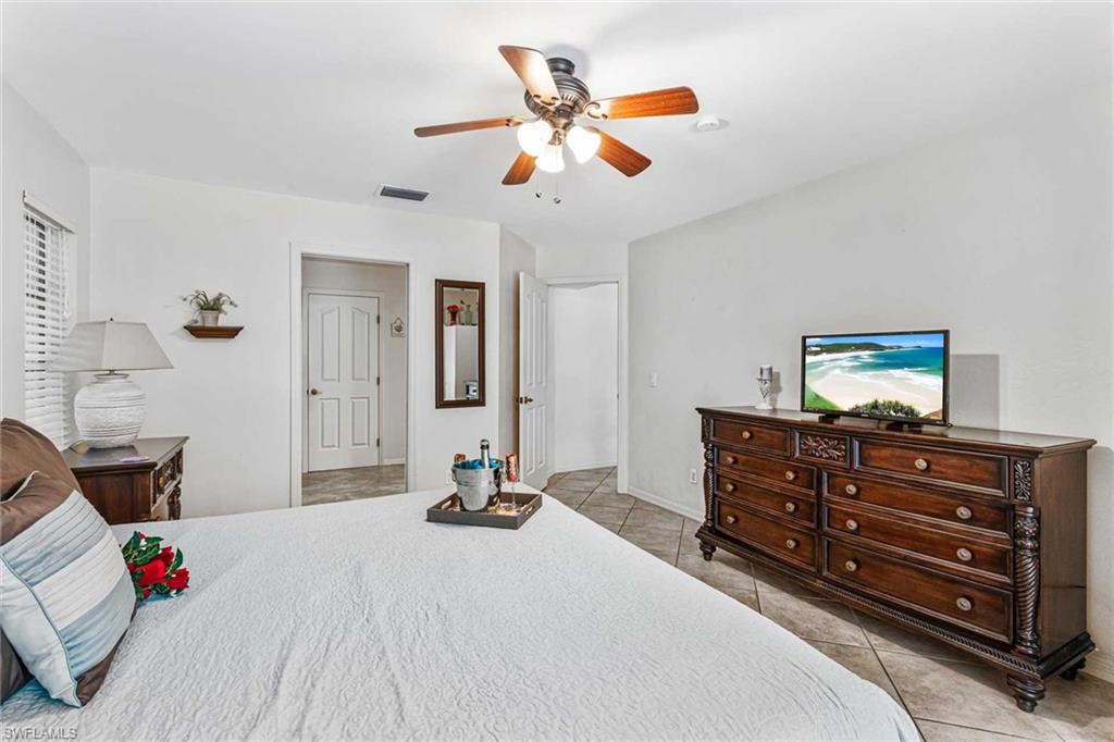 The primary bedroom has a King bed, sliders to the pool & flat screen TV