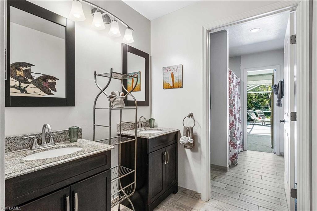 The guest bathroom has two sinks, a shower & doubles as the pool bathroom