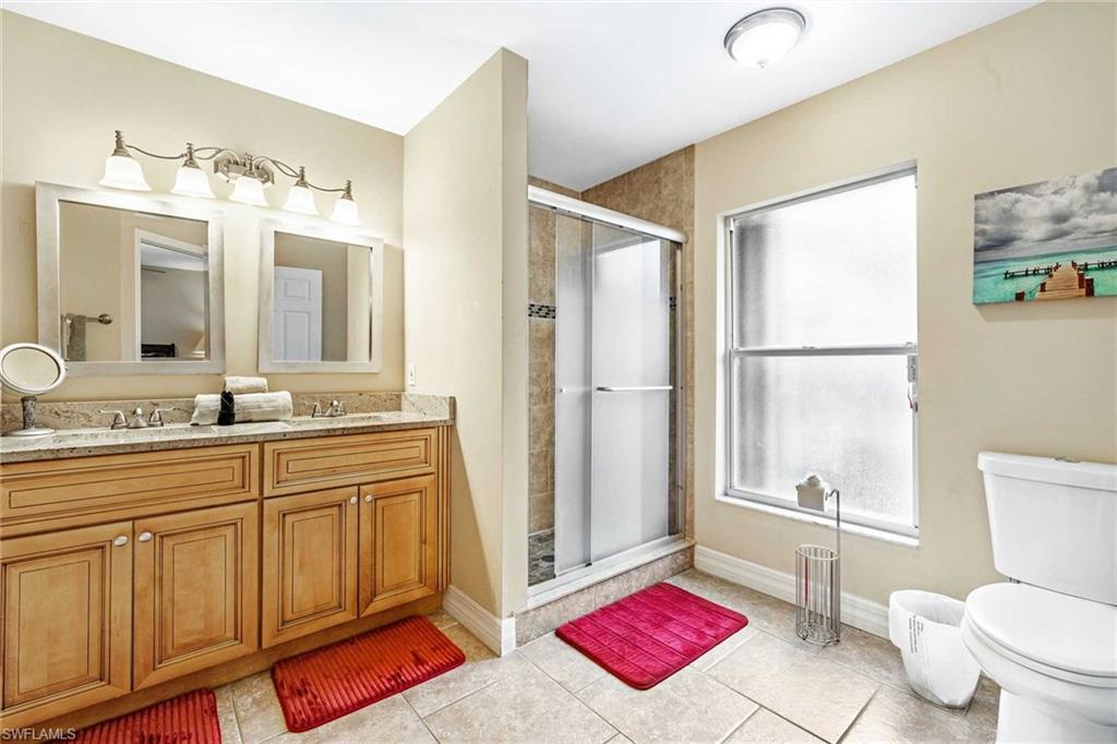 The primary bathroom has a double-sink vanity & shower