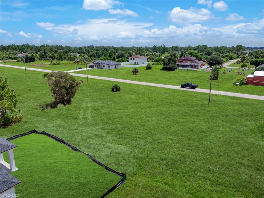 Expansive green space featuring a cleared lot