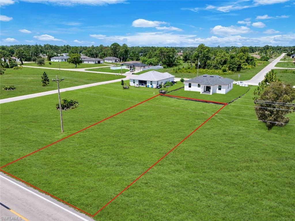Expansive green lot featuring level terrain and a clear boundary outline