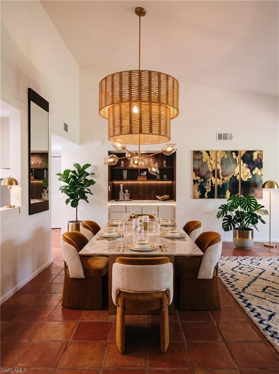 Vaulted ceiling featuring a tiered woven chandelier